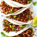 Tofu ground beef served in vegan tacos and topped with avocado and cilantro.