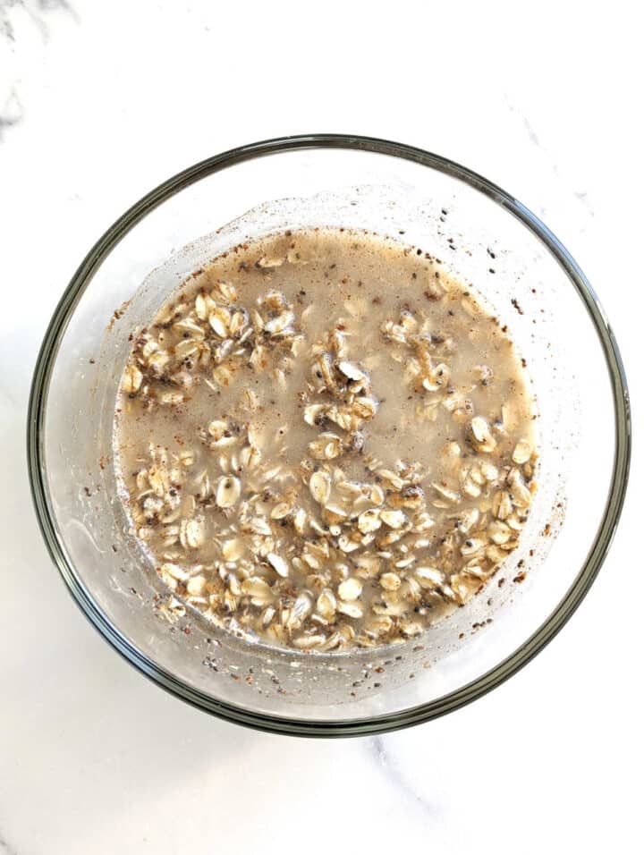 Overnight oats with water in a bowl immediately after mixing all ingredients together.