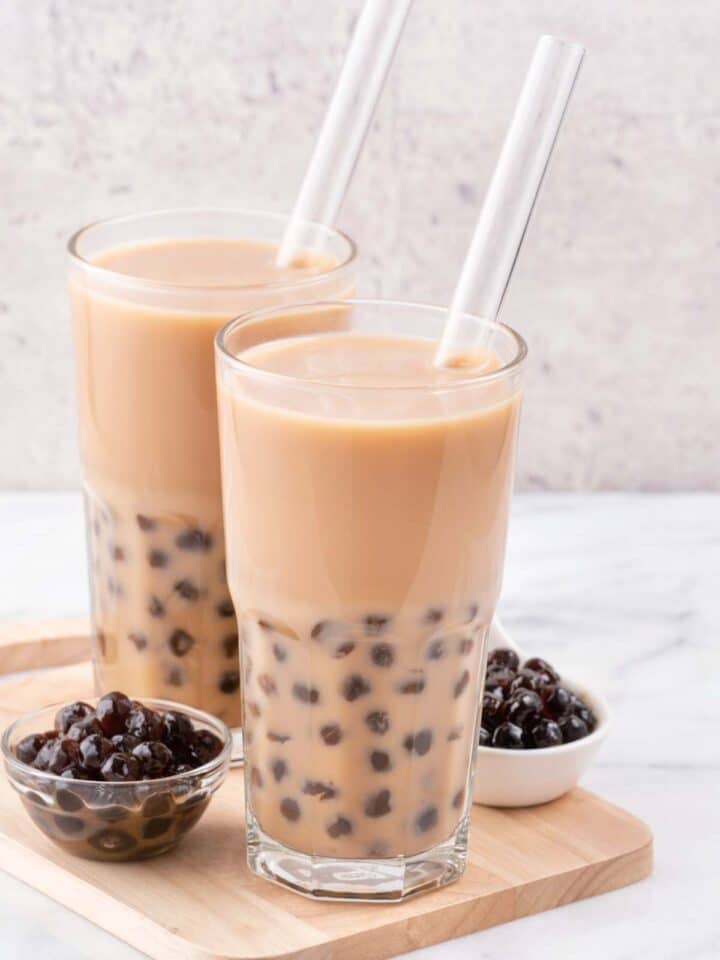 Vegan bubble tea made with tapioca in two glasses with straws.