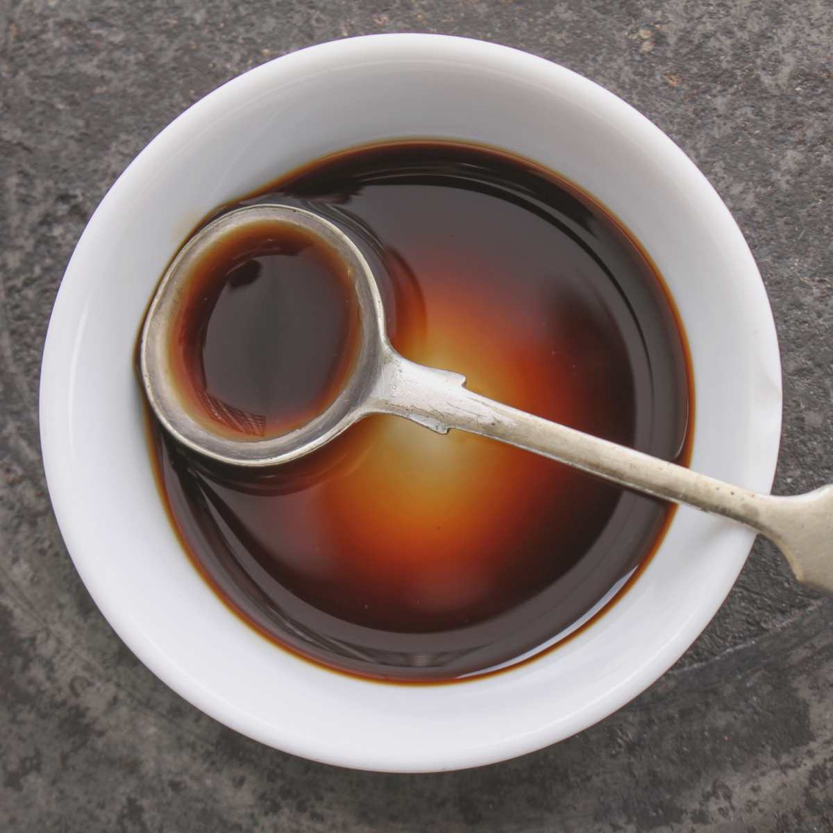 Bowl of Worcestershire sauce with a spoon.