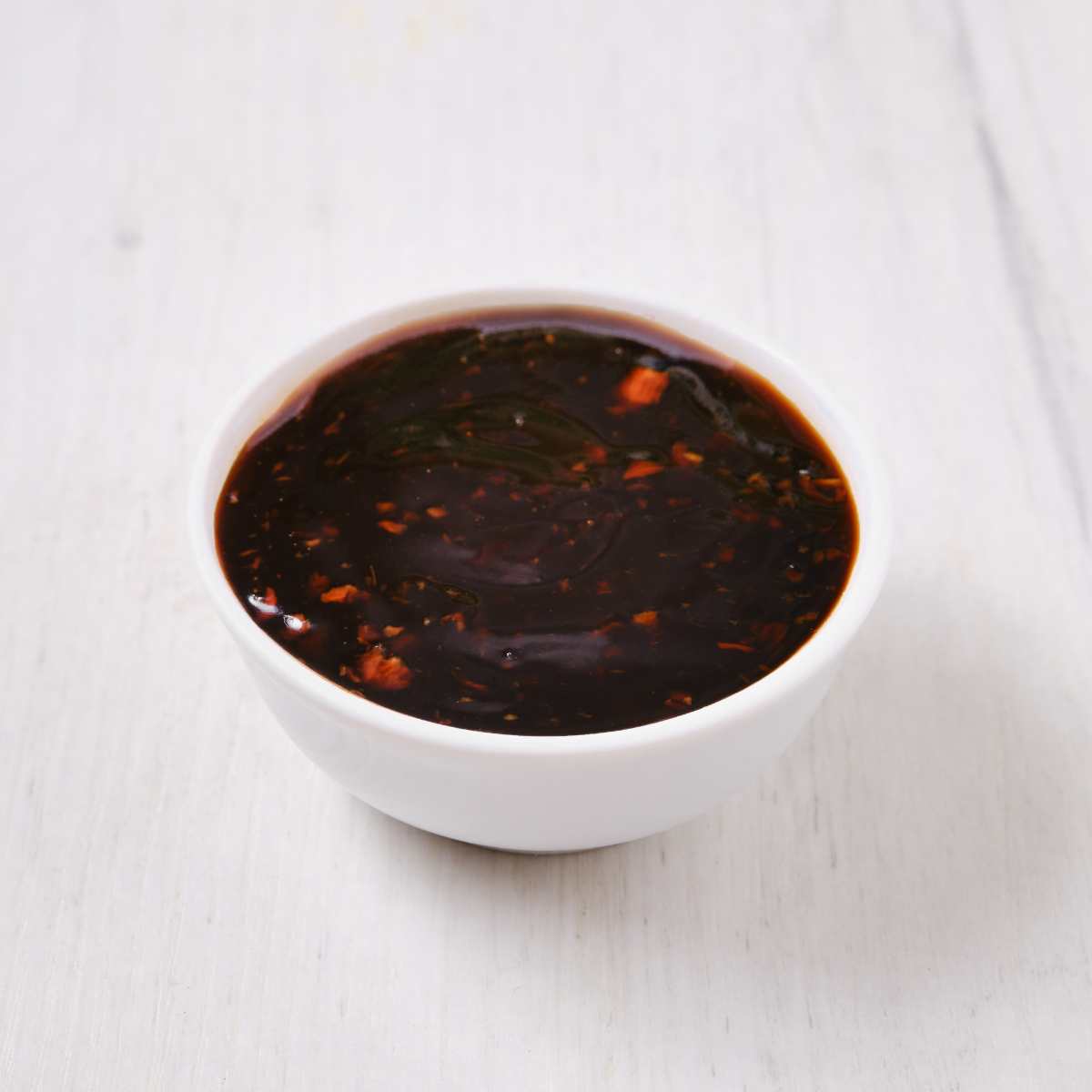 A bowl of teriyaki sauce.