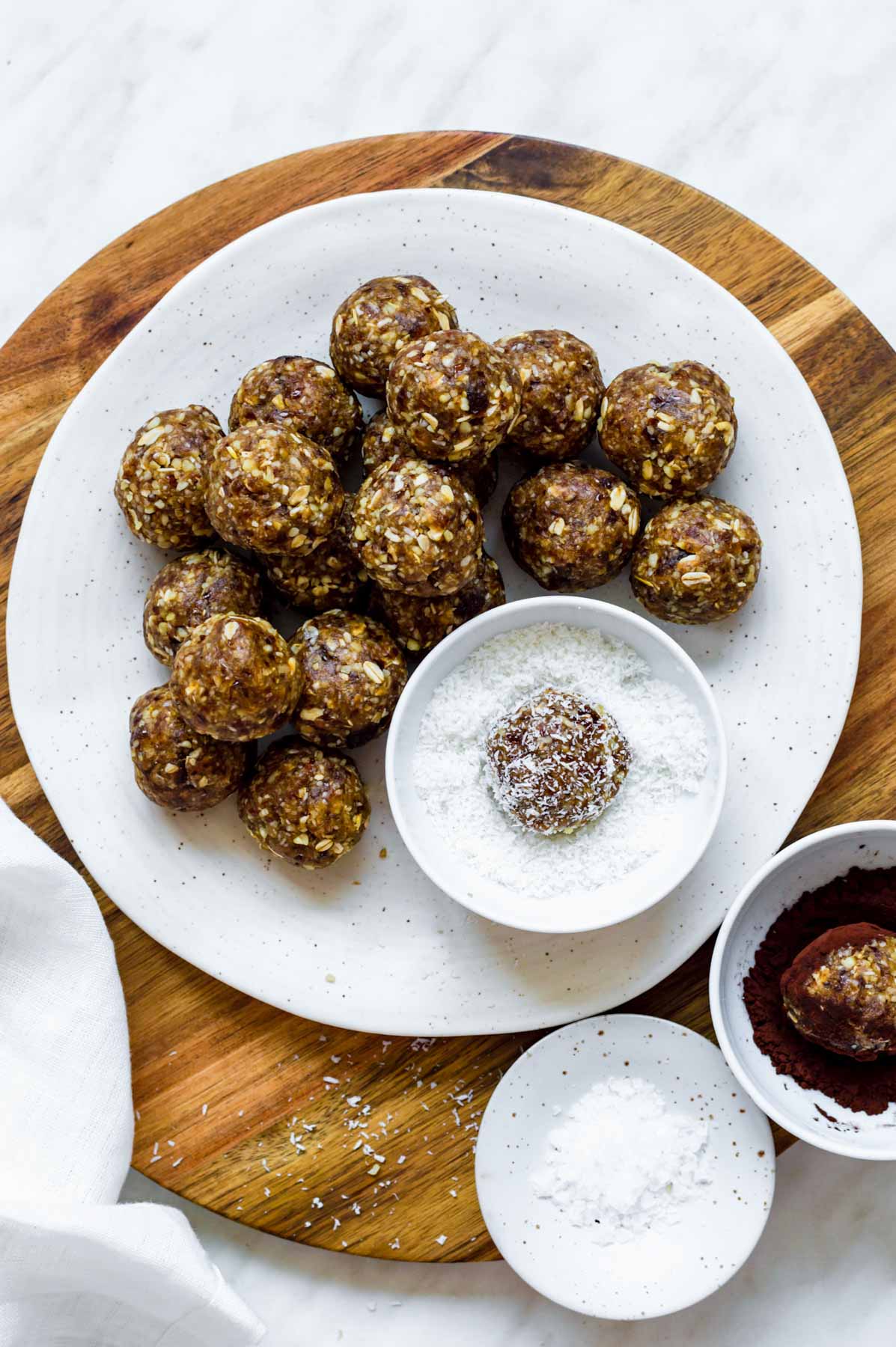 Rolling bliss balls in shredded coconut.