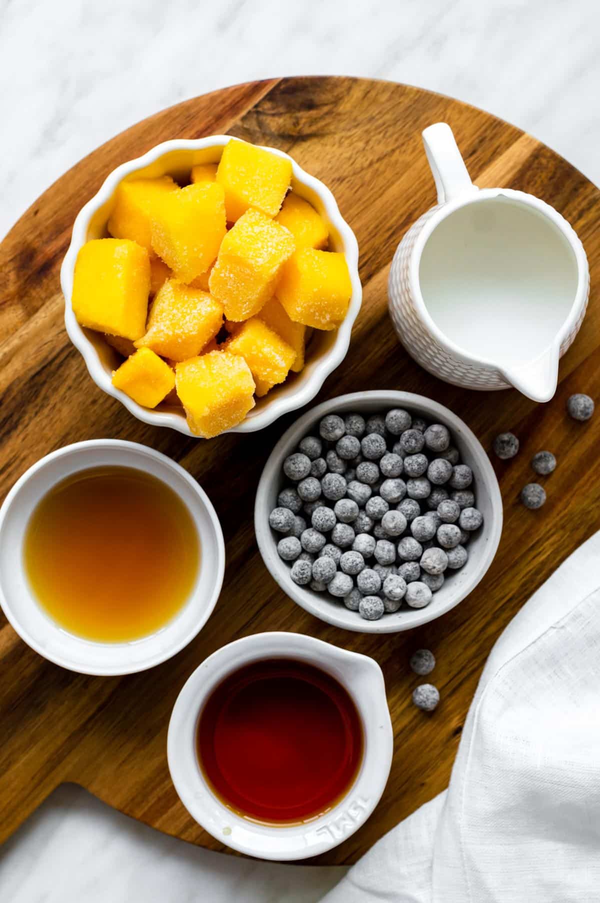 Gathered ingredients for making mango bubble tea.