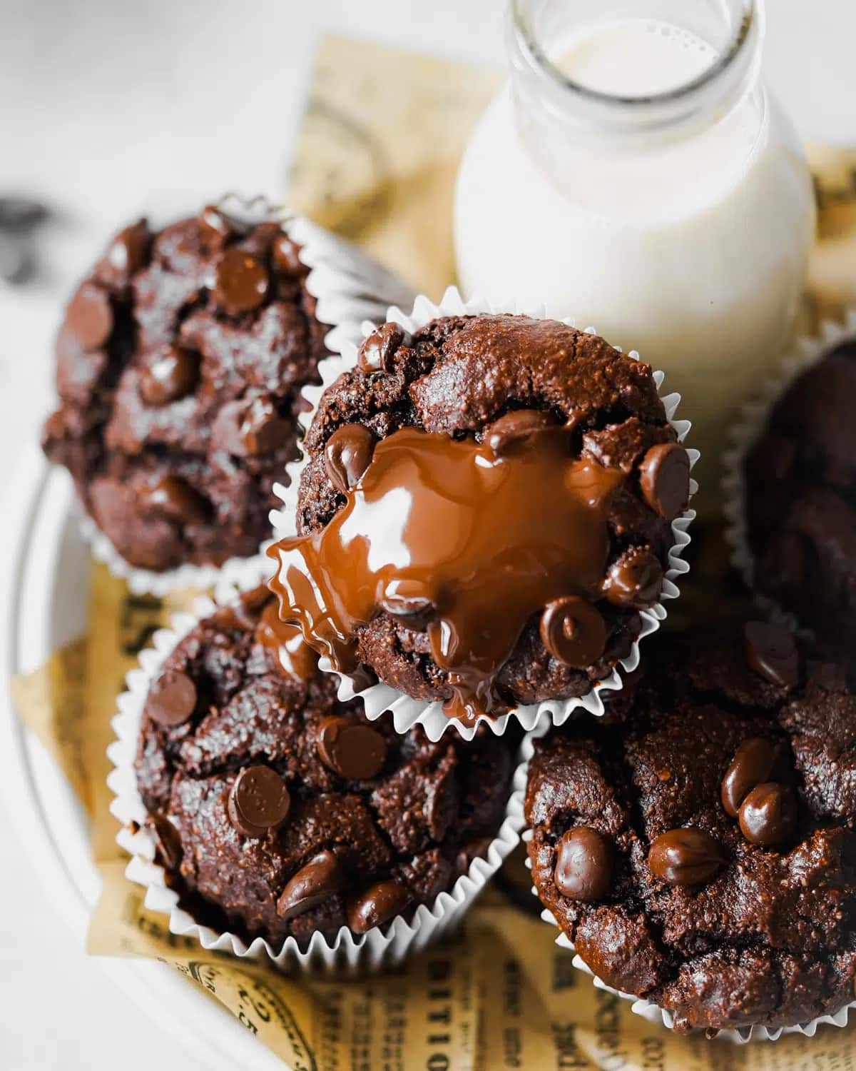 Vegan chocolate muffins drizzled with melted dairy-free chocolate.