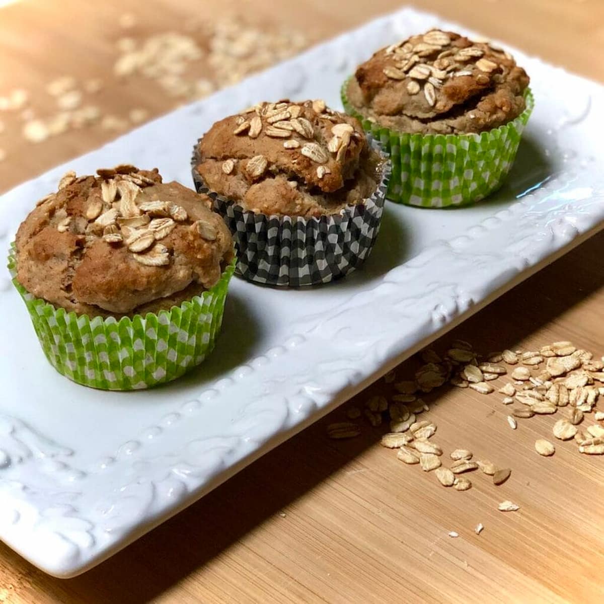 Three vegan oatmeal muffins on a platter.