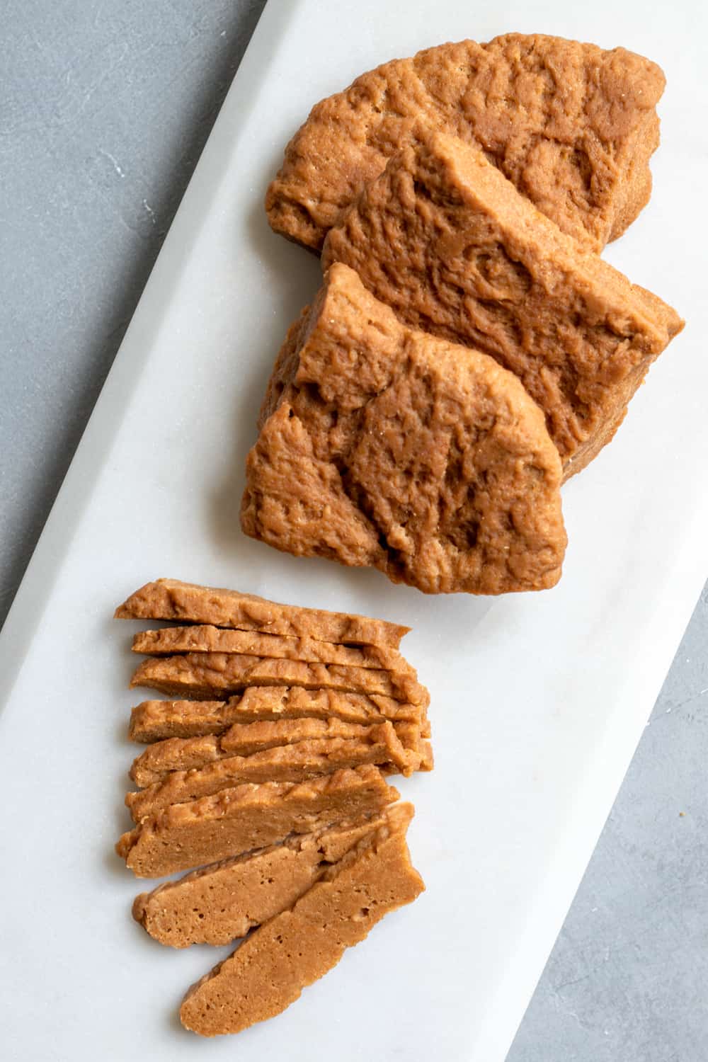 Steamed seitan on a serving platter, cut and sliced.