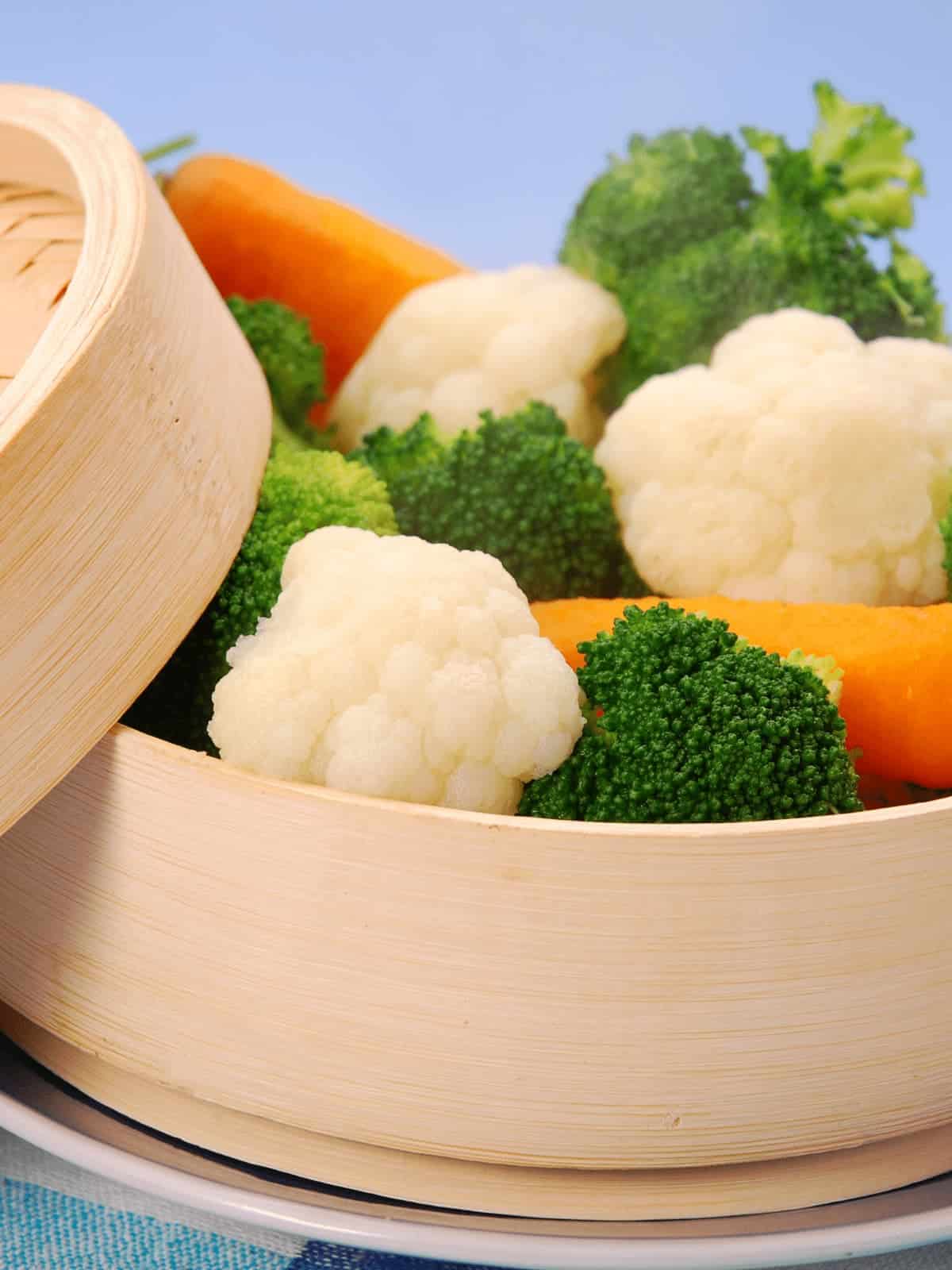 Steamed veggies in a bamboo steamer basket.