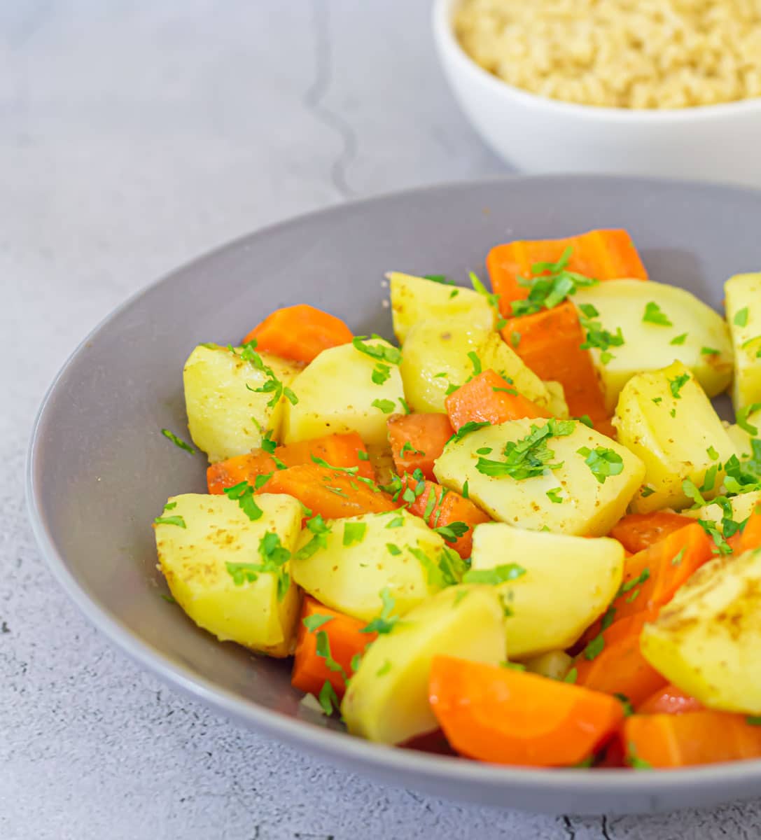 Steamed potatoes and carrots in a bowl.
