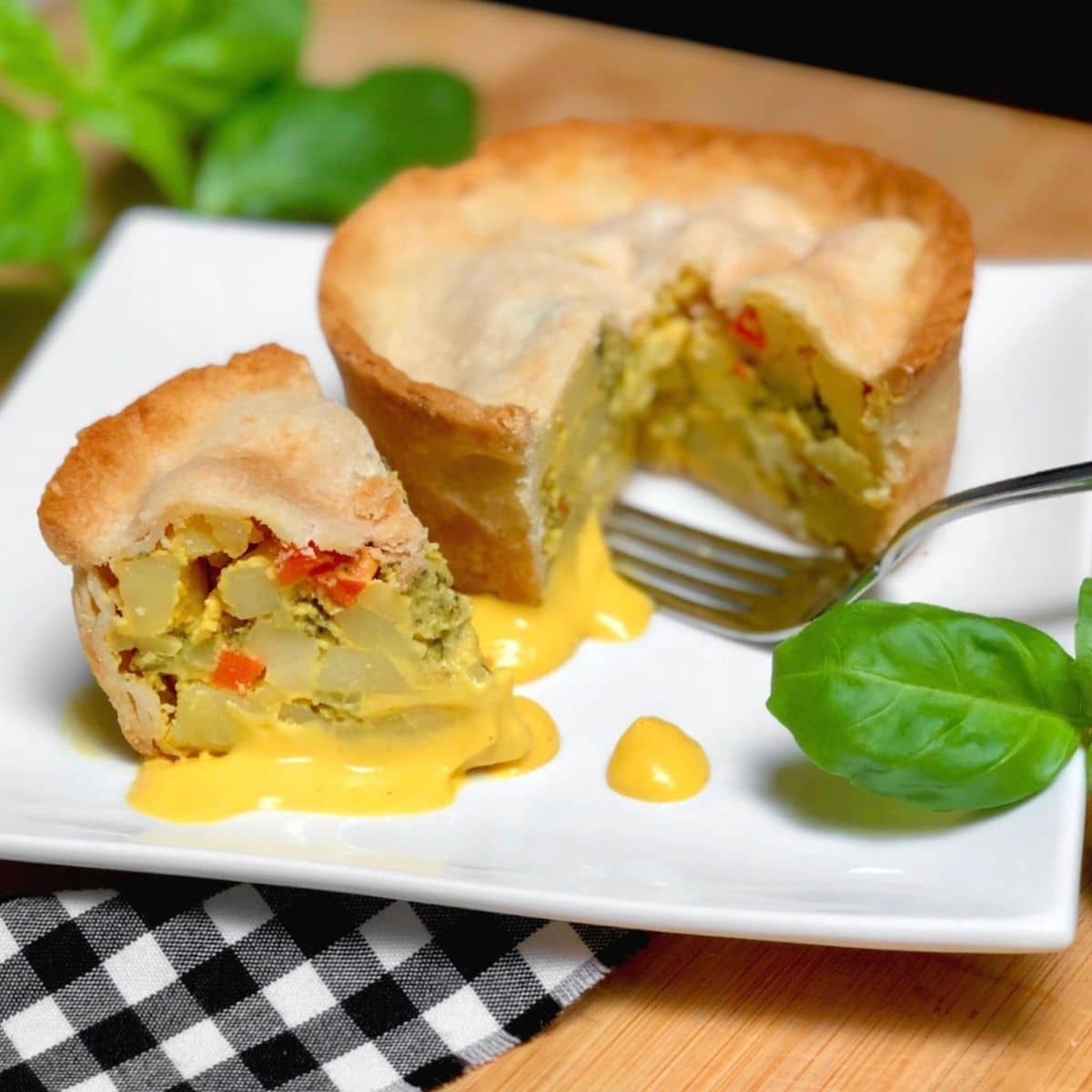 A steamed broccoli cheese pot pie with a quarter of it sliced out.