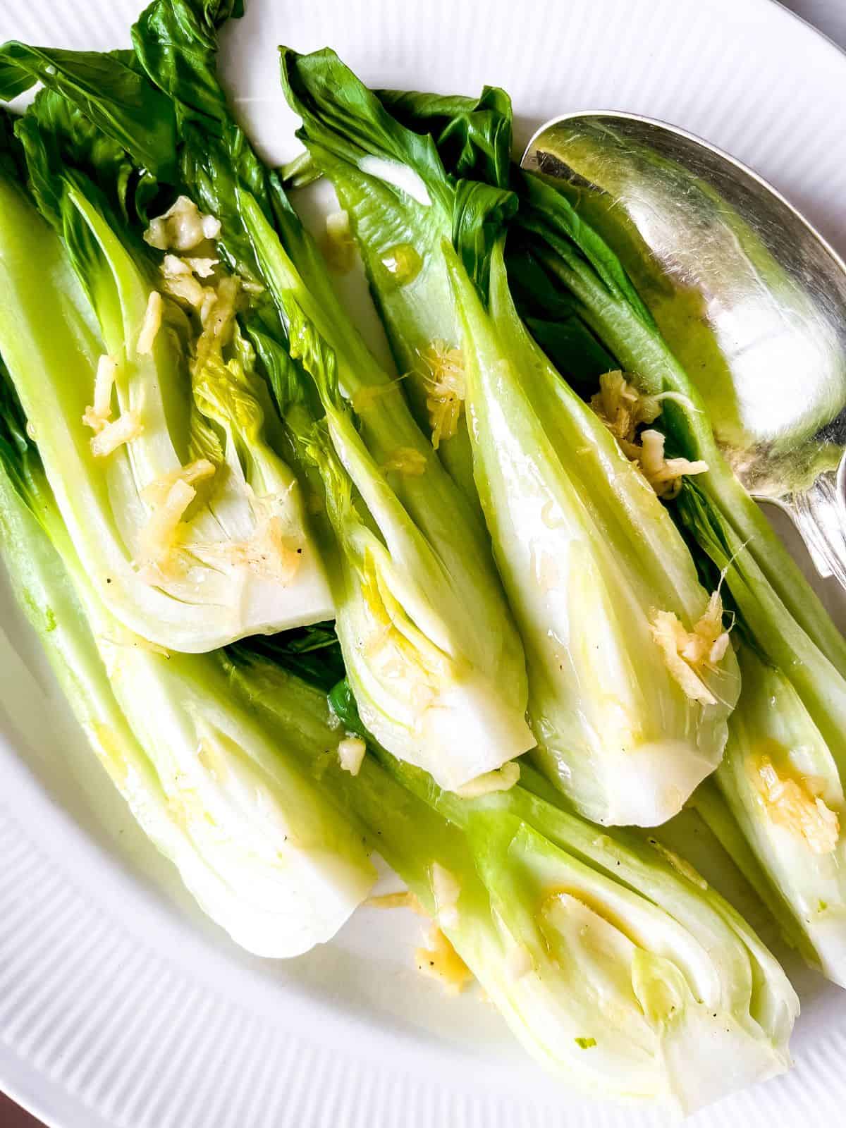Steamed pak choi on a plate.