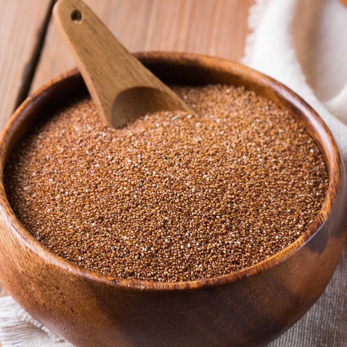 A wooden bowl full of dry teff.