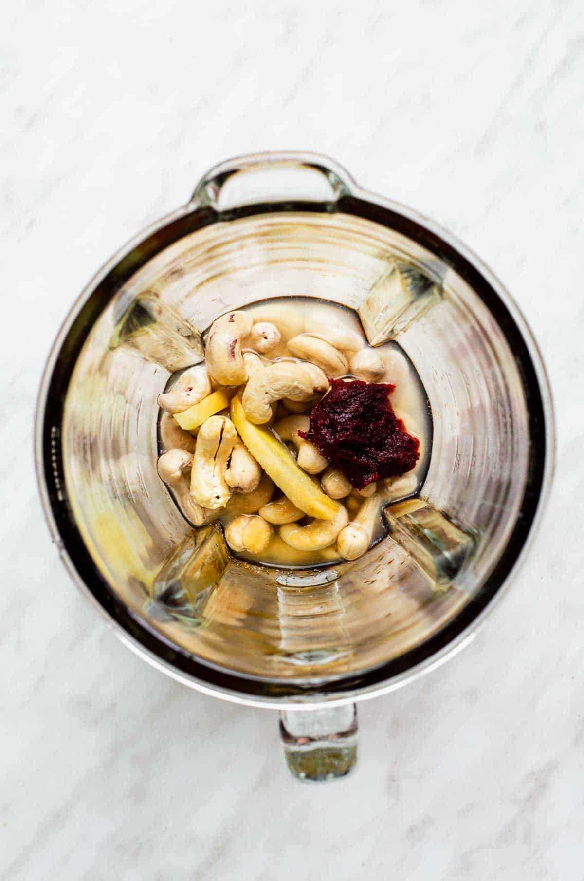 Ingredients for the spicy cashew dressing in a blender pitcher.