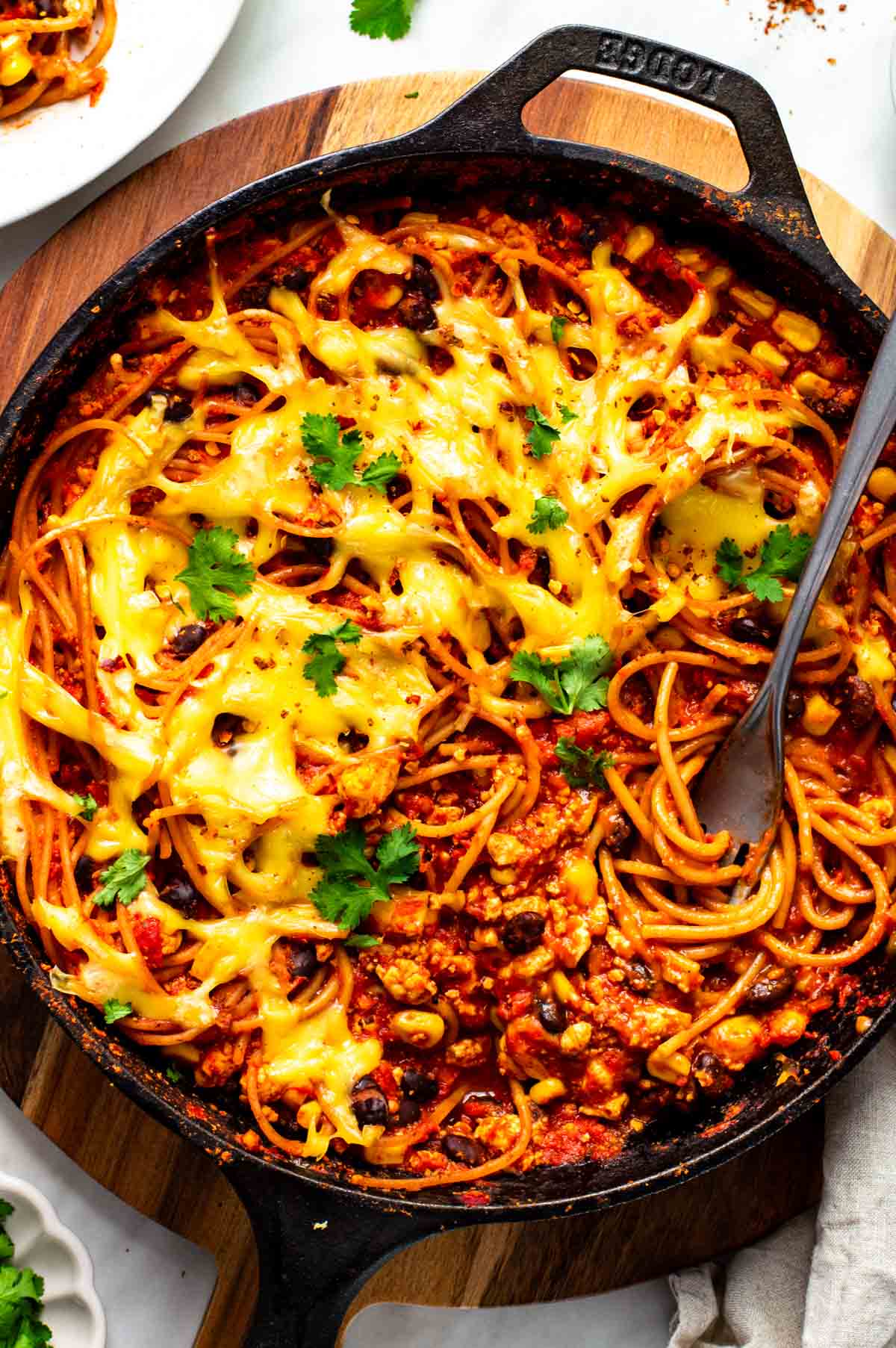 A fork twirling some of the Mexican spaghetti in the pan.