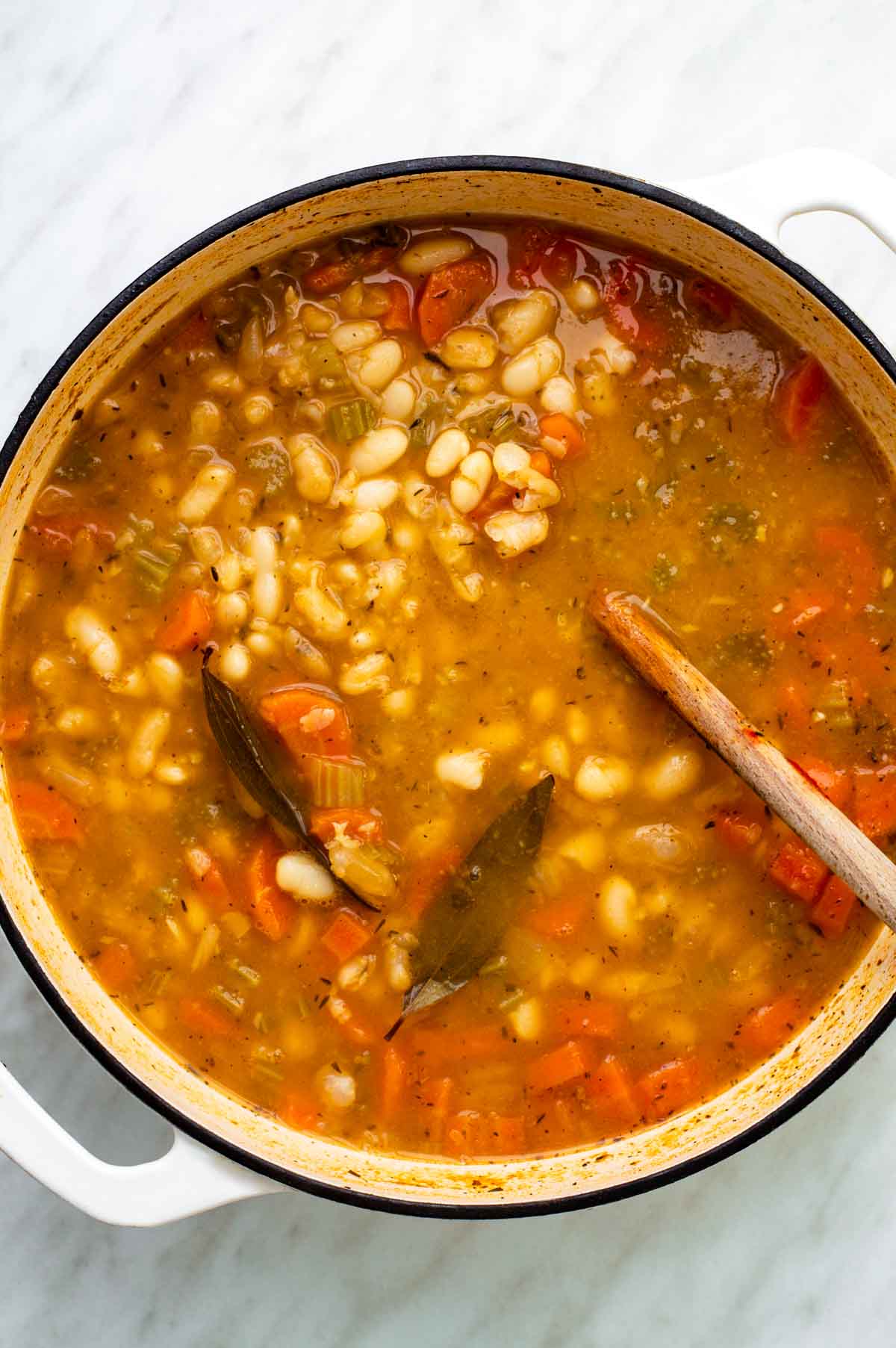 Cooked navy bean soup in a large pot.