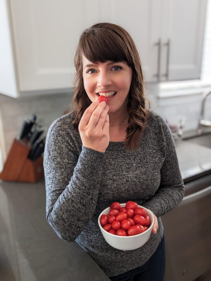 Rachel holding a bowl of cherry tomatoes.