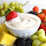 Vegan fruit dip in a bowl, served with a variety of fruit.