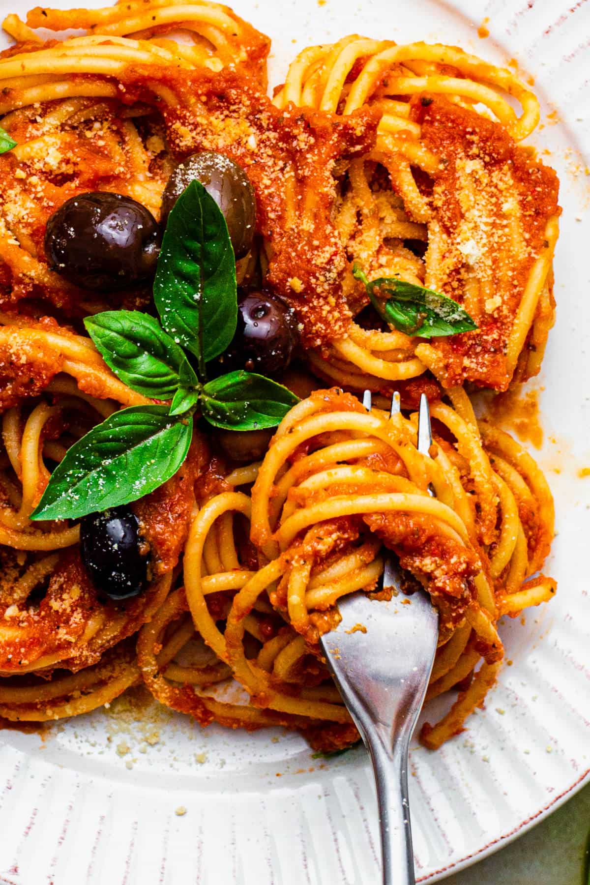 The hidden veggie pasta sauce served over spaghetti, with fresh basil leaves and olives.