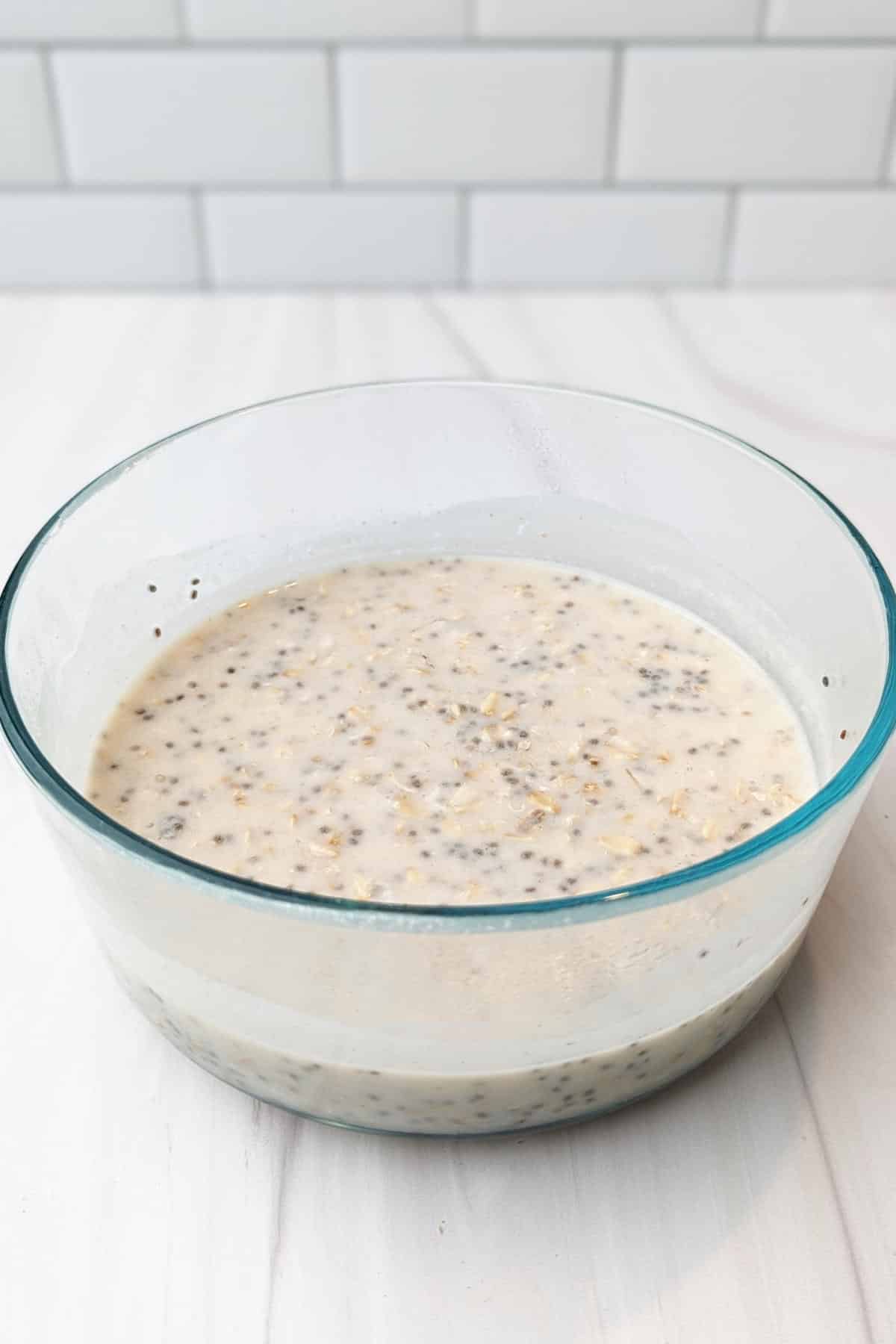 The soaked and creamy blueberry cheesecake overnight oats in a bowl.