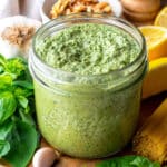 Vegan walnut pesto in a glass jar.