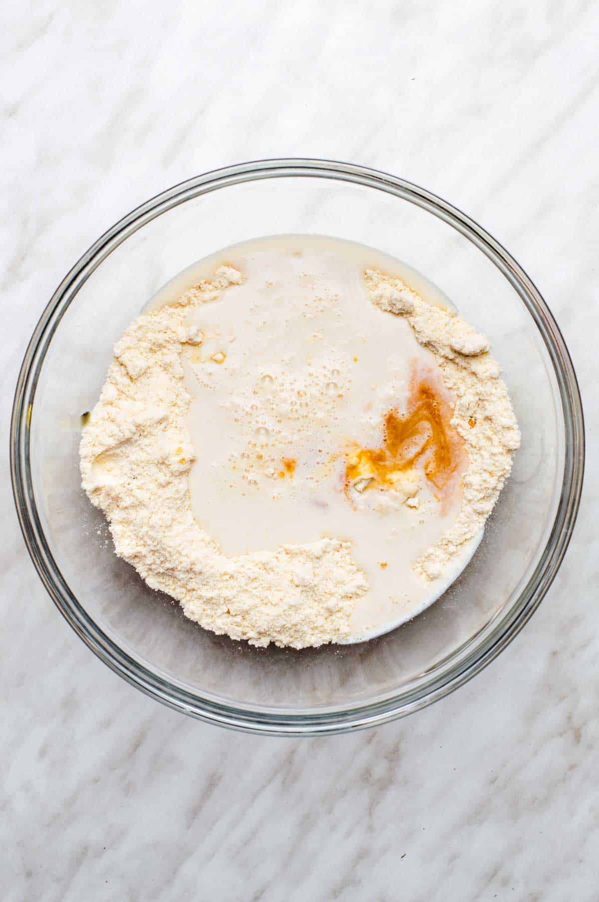 Ingredients for vegan bisquick pancakes added to a bowl.
