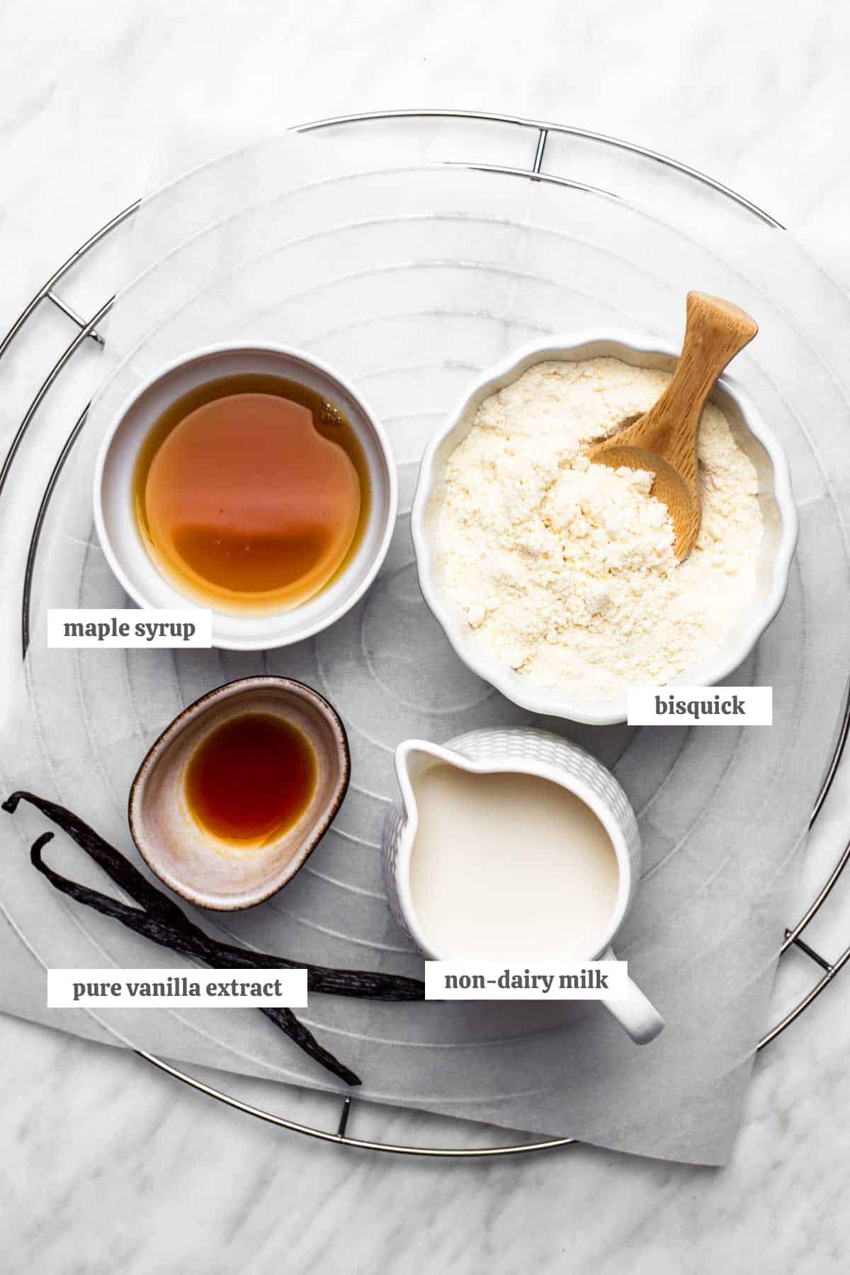 Gathered ingredients for these vegan Bisquick pancakes measured out into individual bowls with labels.