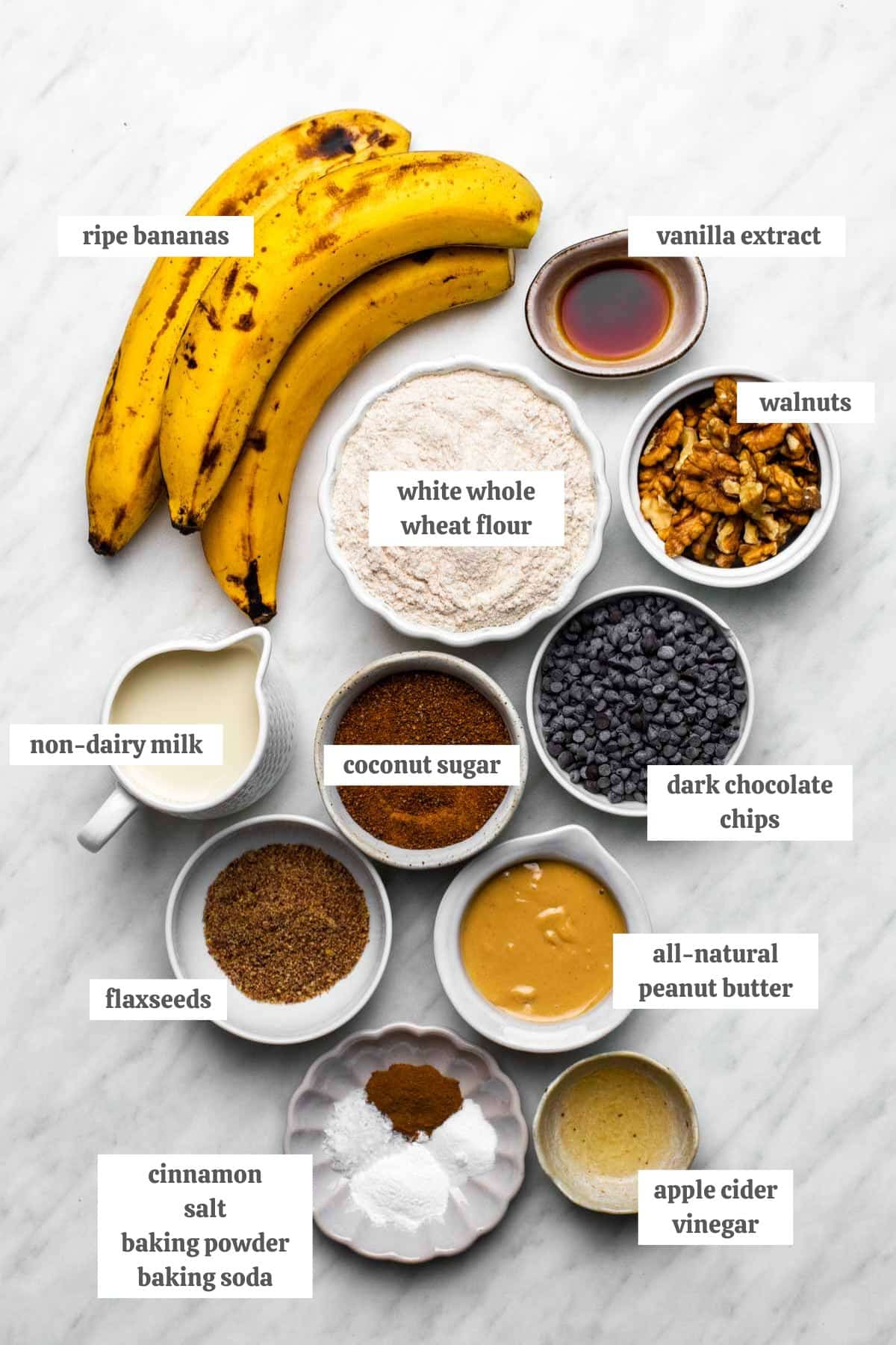 The ingredients for wfpb banana bread measured into individual bowls with labels.