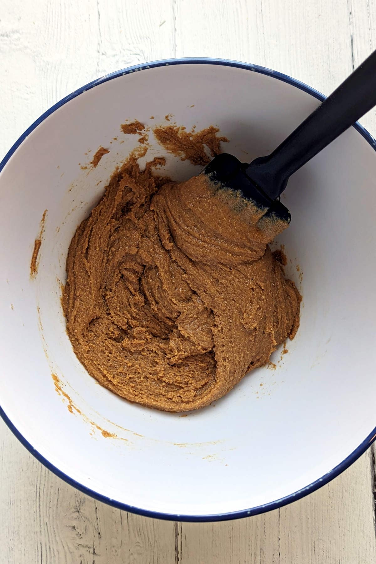 Peanut butter and brown sugar mixed together in a large mixing bowl.