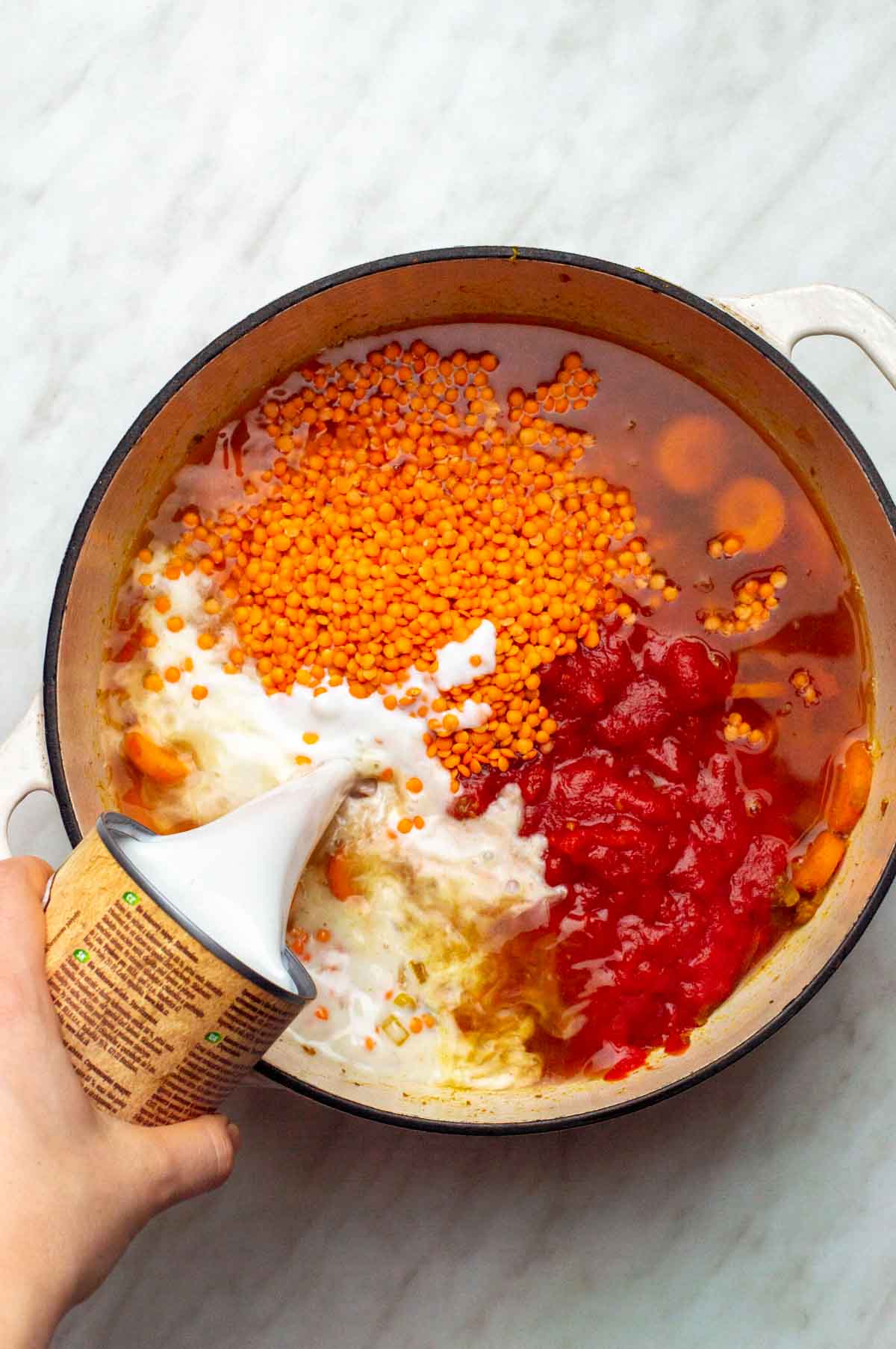 Ingredients for this carrot lentil soup added to a large stock pot.