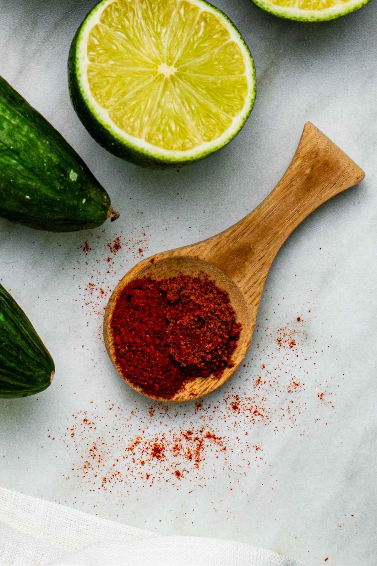 A wooden scoop filled with homemade chili lime seasoning.