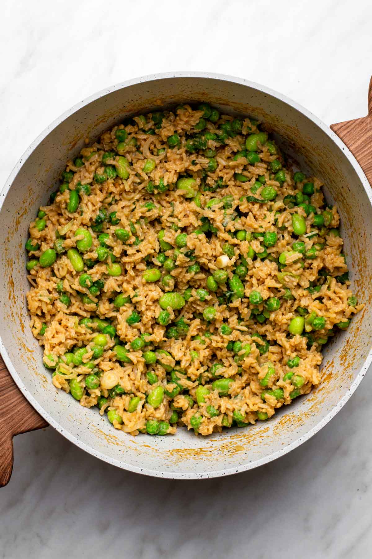 Peanut butter rice mixed with peas and green onions.