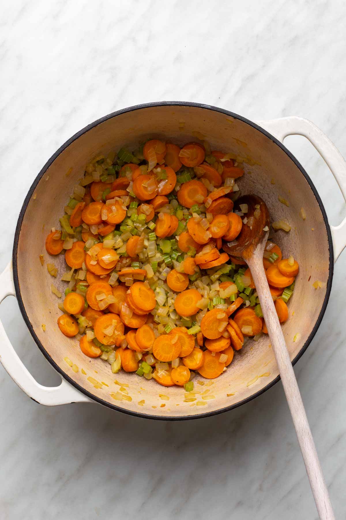 A mix of chopped vegetables, lentils, and seasonings prepared for making cauliflower lentil soup.