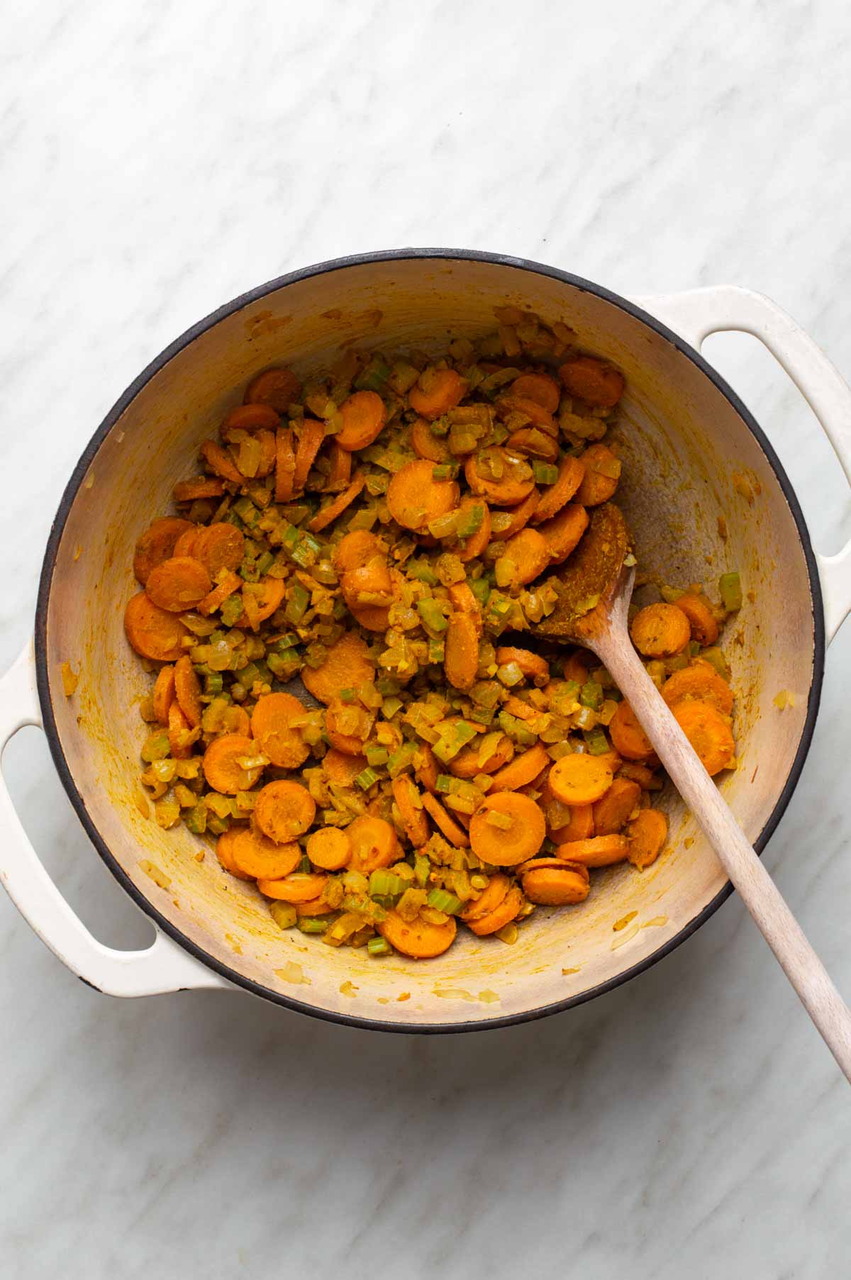 A mix of chopped vegetables, lentils, and seasonings prepared for making cauliflower lentil soup.