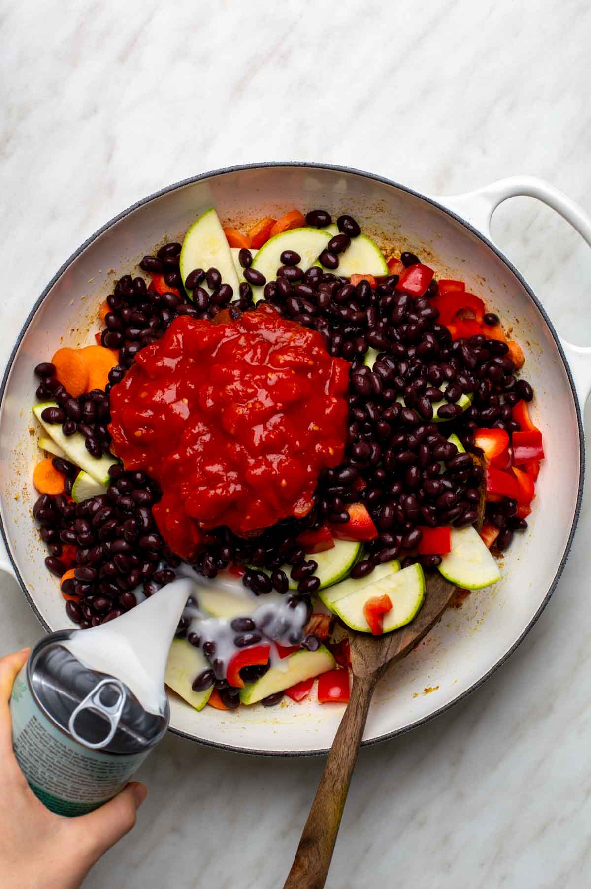Carrots, bell pepper, and zucchini added to the pan and coated in toasted spices for black bean curry.