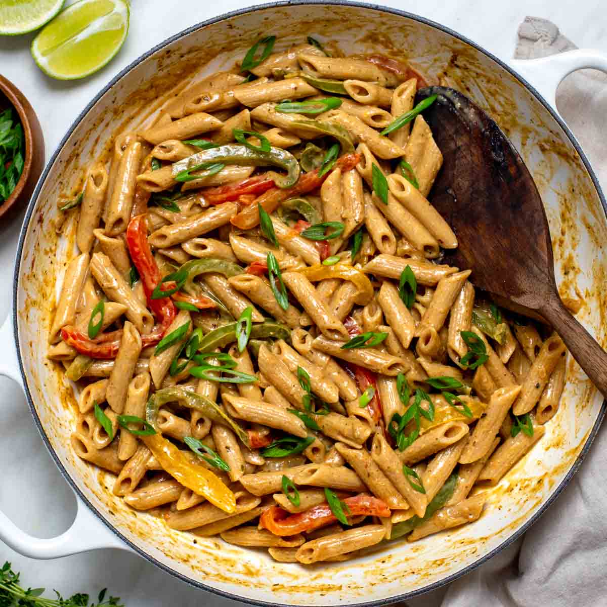 Vegan Rasta Pasta served hot and topped with scallions and thyme.