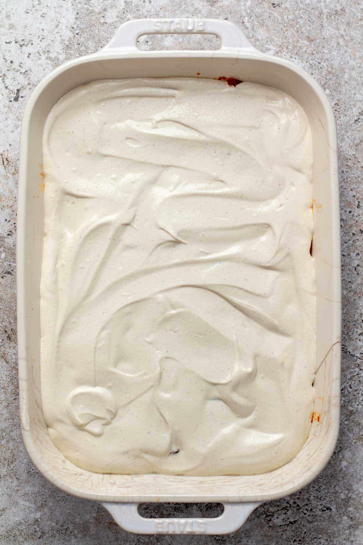 Cashew béchamel spread above the layered ingredients.