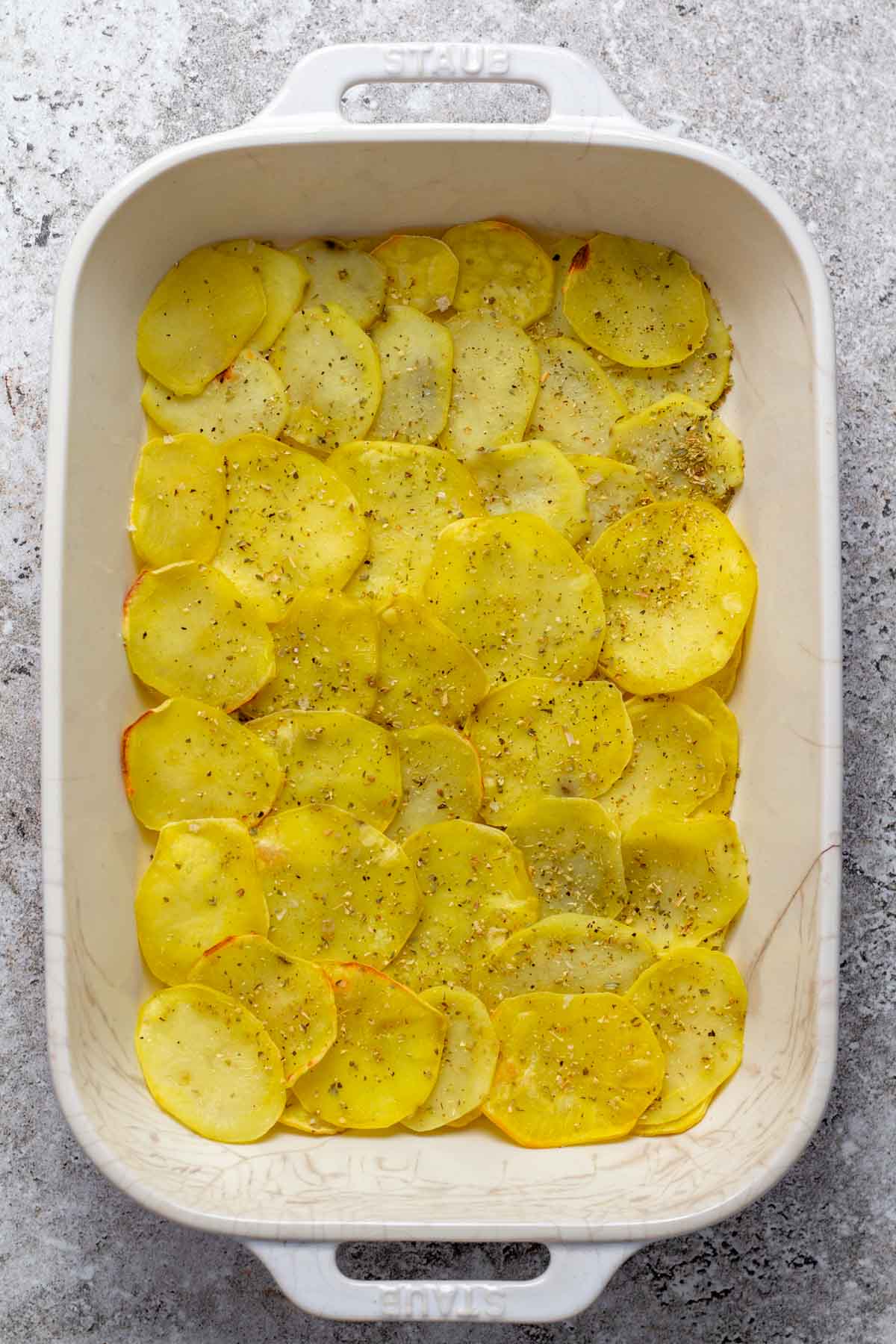 Seasoned roasted potatoes in a baking dish.